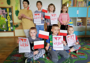 Dzieci pokazują swoje prace plastyczne z okazji świąt majowych