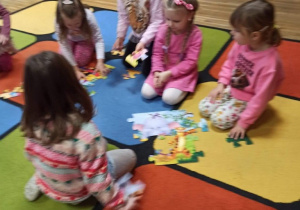 Dziewczynki układają puzzle.