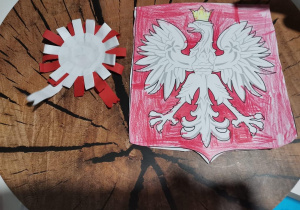 Symbole narodowe- orzeł biały w złotej koronie na czerwonym tle oraz odznaka patriotyczna Filipa M.
